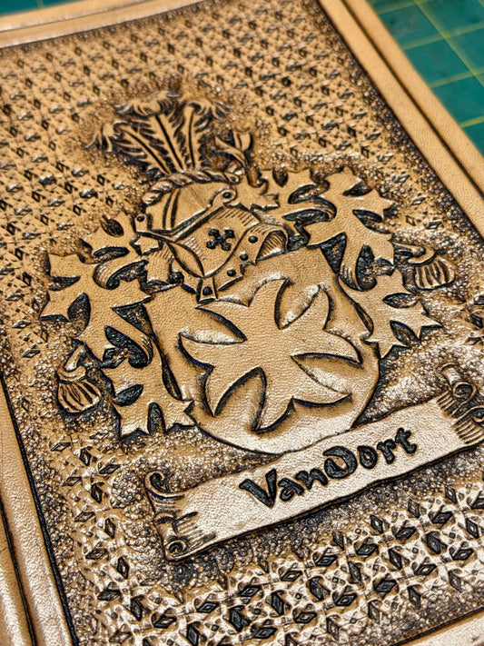 Custom handmade leather Bible with hand-tooled family crest on front cover