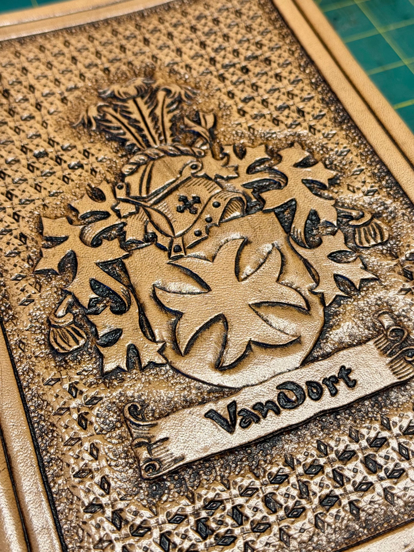 Custom handmade leather Bible with hand-tooled family crest on front cover